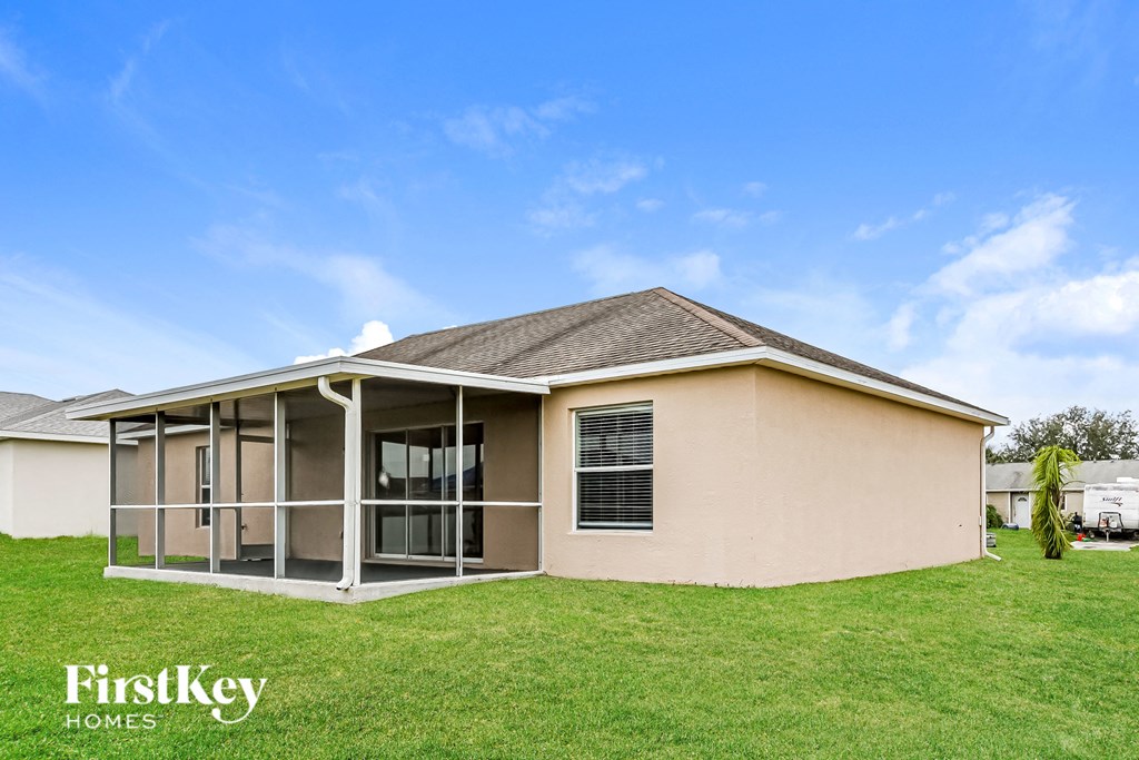 a home with a screened porch and a lawn