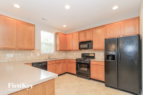 a kitchen with black appliances and wooden cabinets
