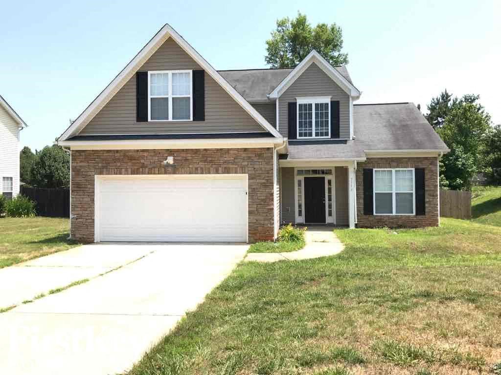 a house with a lawn and a driveway