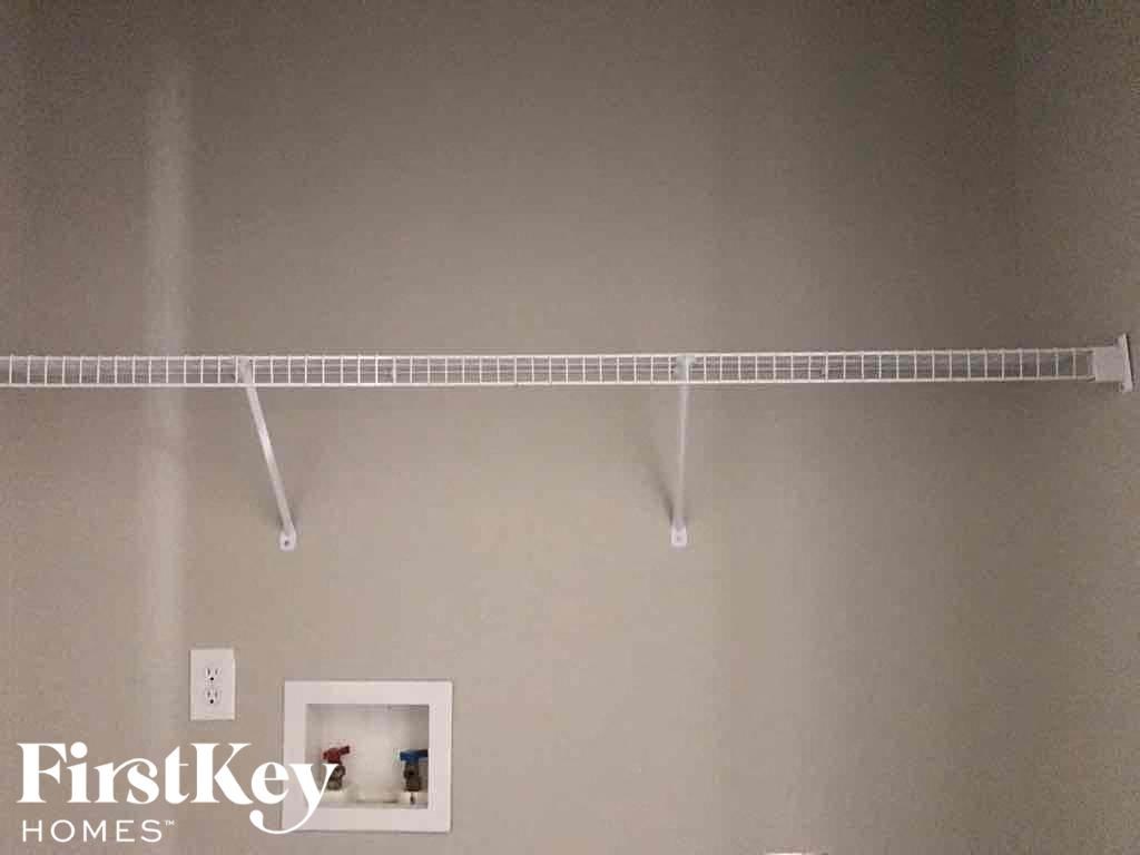 a rack hanging on a wall with a picture on it