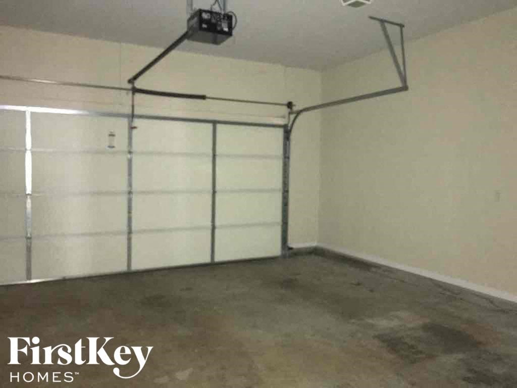 a clean and empty garage with a white walled garage door