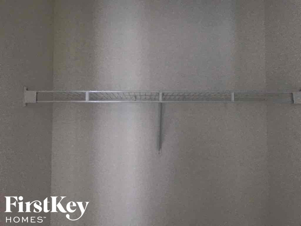 a rack hanging on a wall with a shower curtain