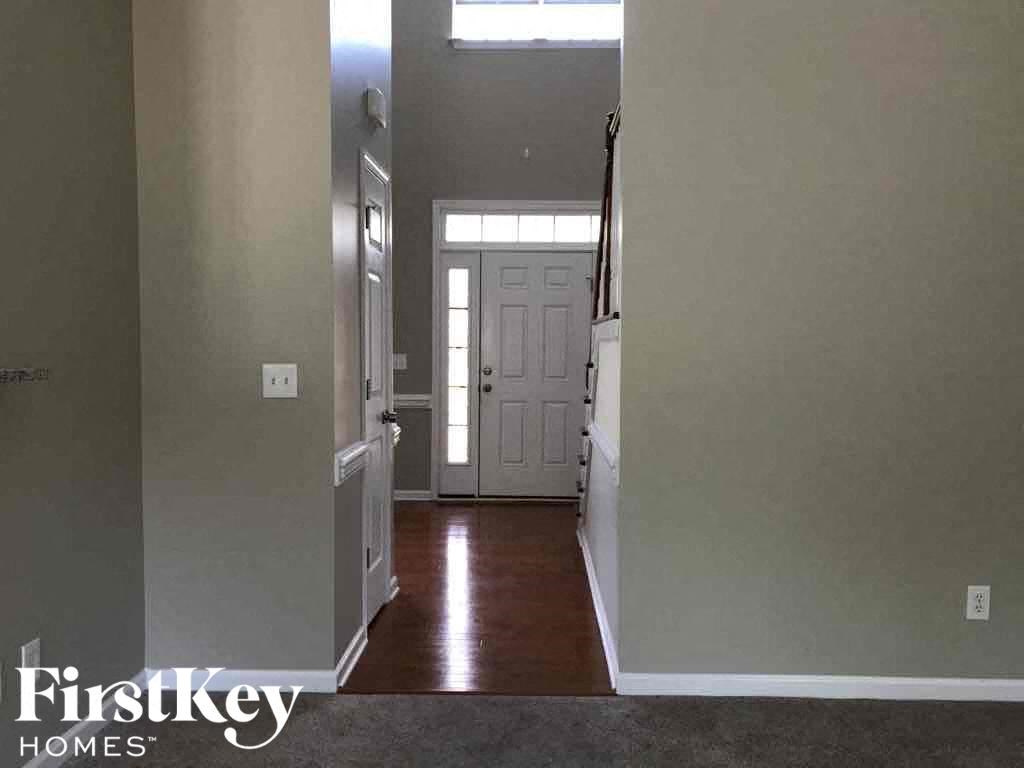 a view of a hallway with a white door in a house