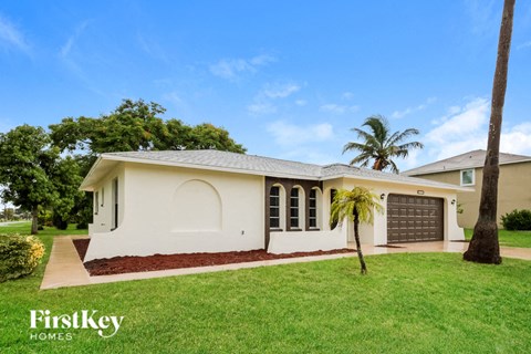 a home with a palm tree in the front yard