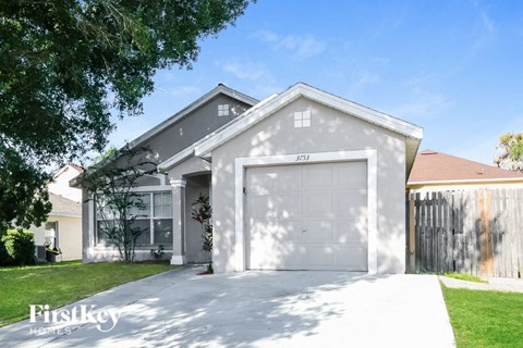 a gray house with a white garage door