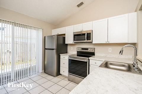 a kitchen with stainless steel appliances and white cabinets