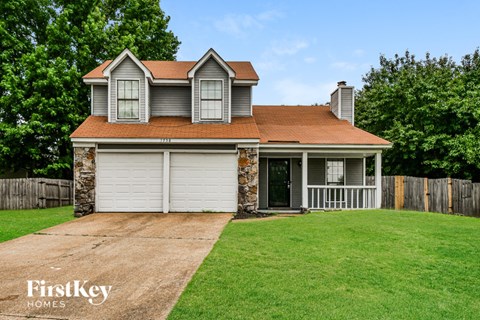 A house with a brown roof and a garage door.
