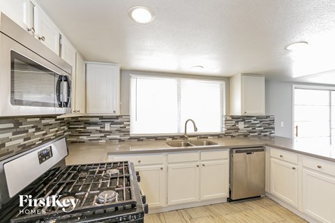 A kitchen with a stove top oven and a dishwasher.