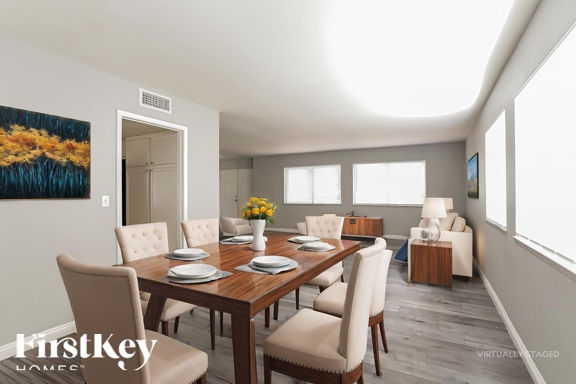 A dining room with a wooden table and chairs.
