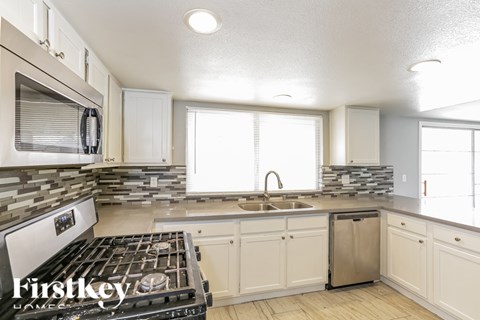 A kitchen with a stove top oven and a dishwasher.