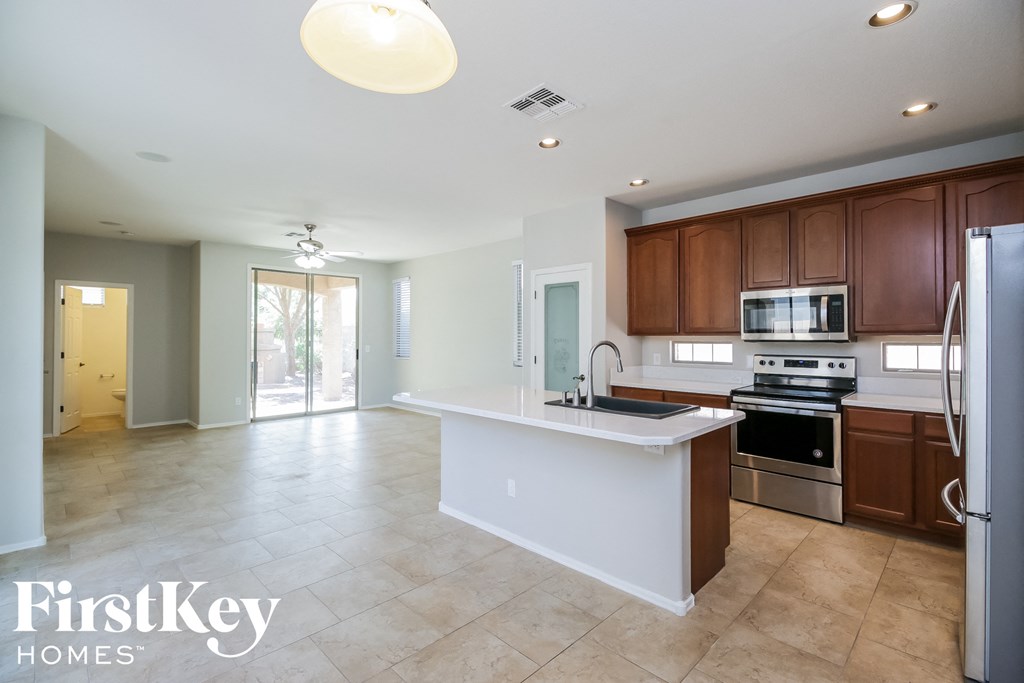 a large kitchen with a large island and stainless steel appliances