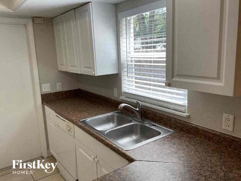 A kitchen with a sink and cabinets.