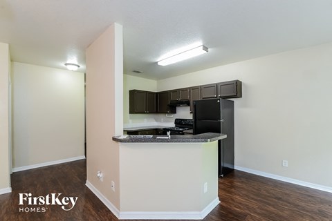 A kitchen area with a counter and cabinets.