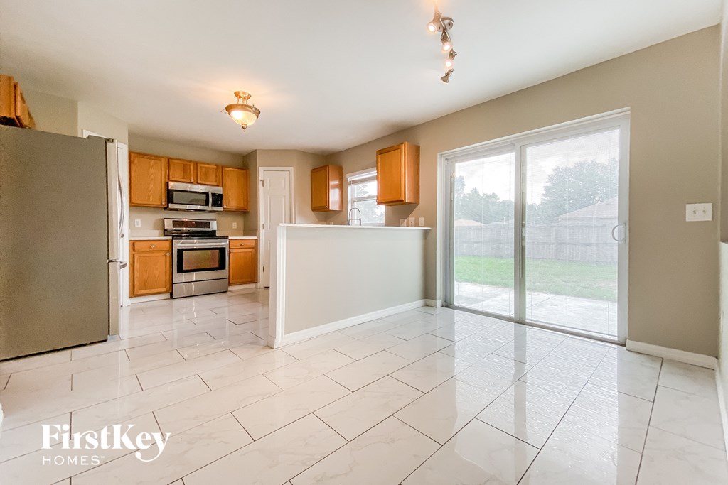 the kitchen is open to the living room and the backyard