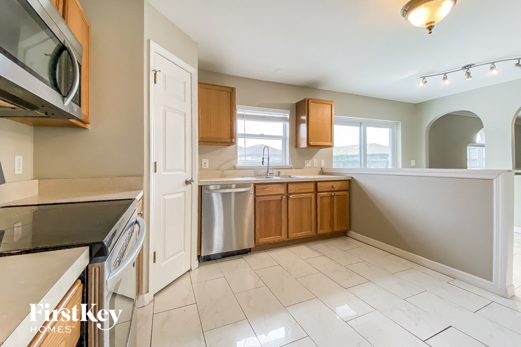 an empty kitchen with a stove and a sink