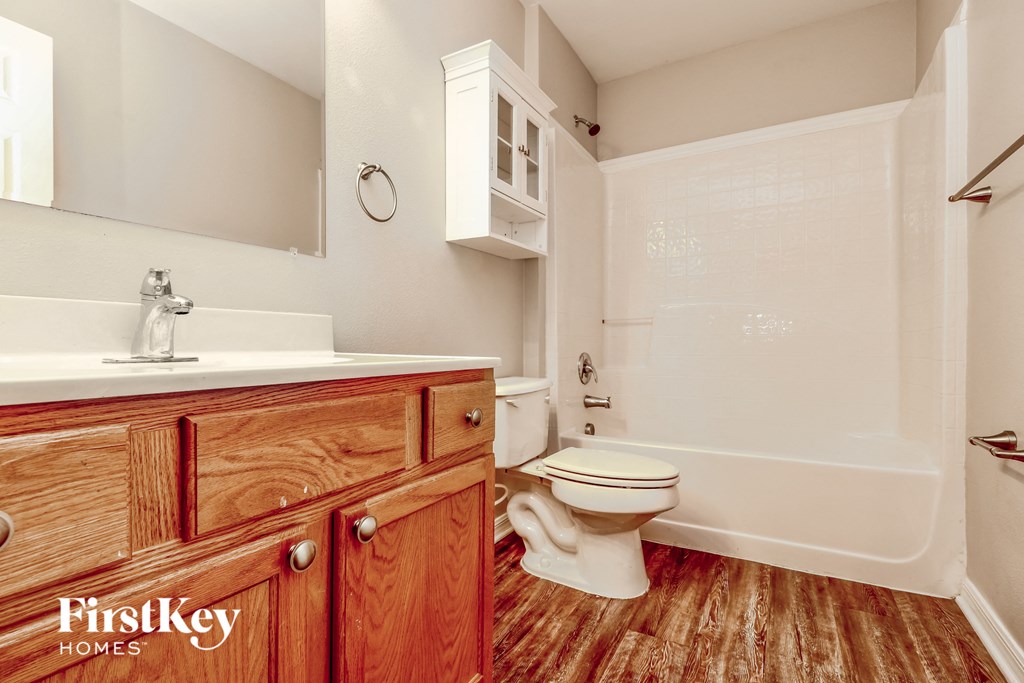 a bathroom with a toilet and a sink and a bath tub