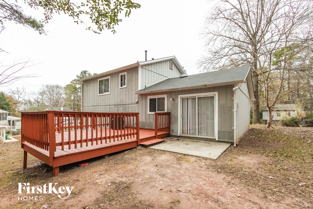 a small house with a deck and a garage