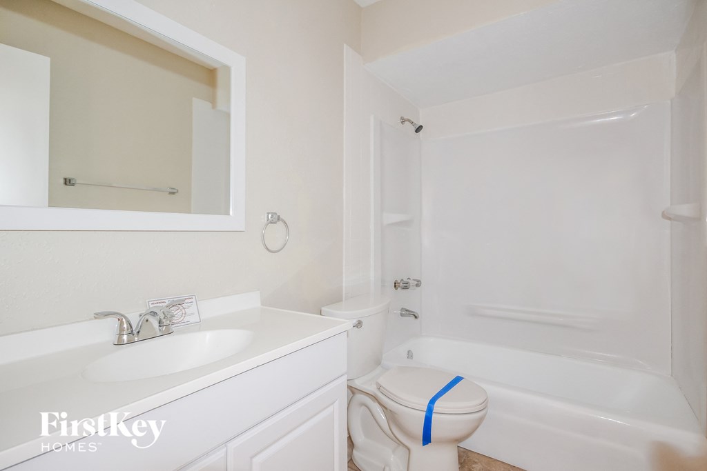 a bathroom with a sink and a toilet and a bath tub
