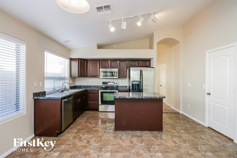 a kitchen with dark wood cabinets and a counter top
