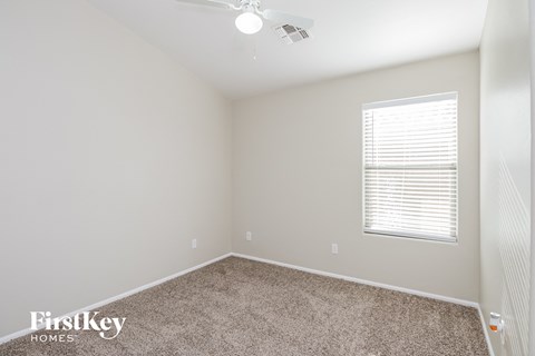 a bedroom with a carpeted floor and a window