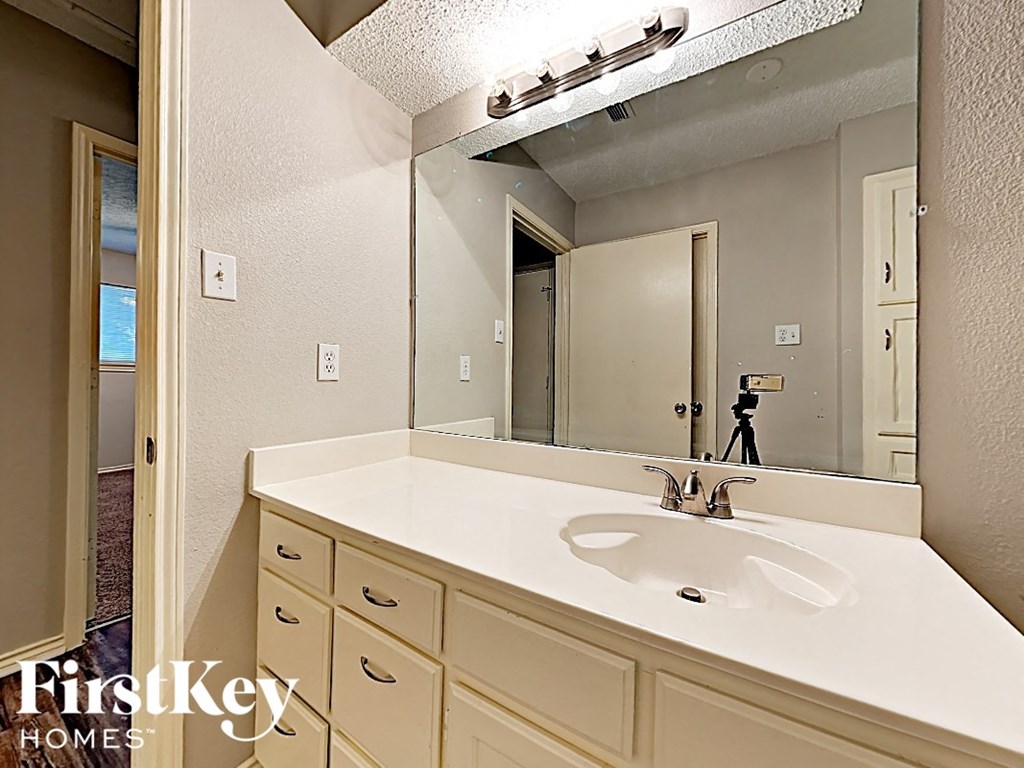 a bathroom with a sink and a large mirror