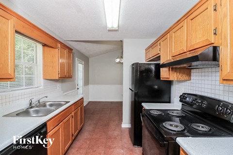 a kitchen with black appliances and wooden cabinets
