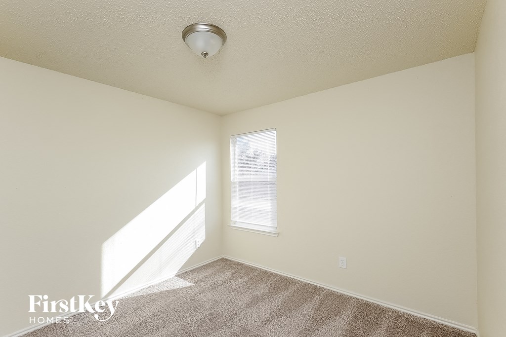 a living room with carpet and a window