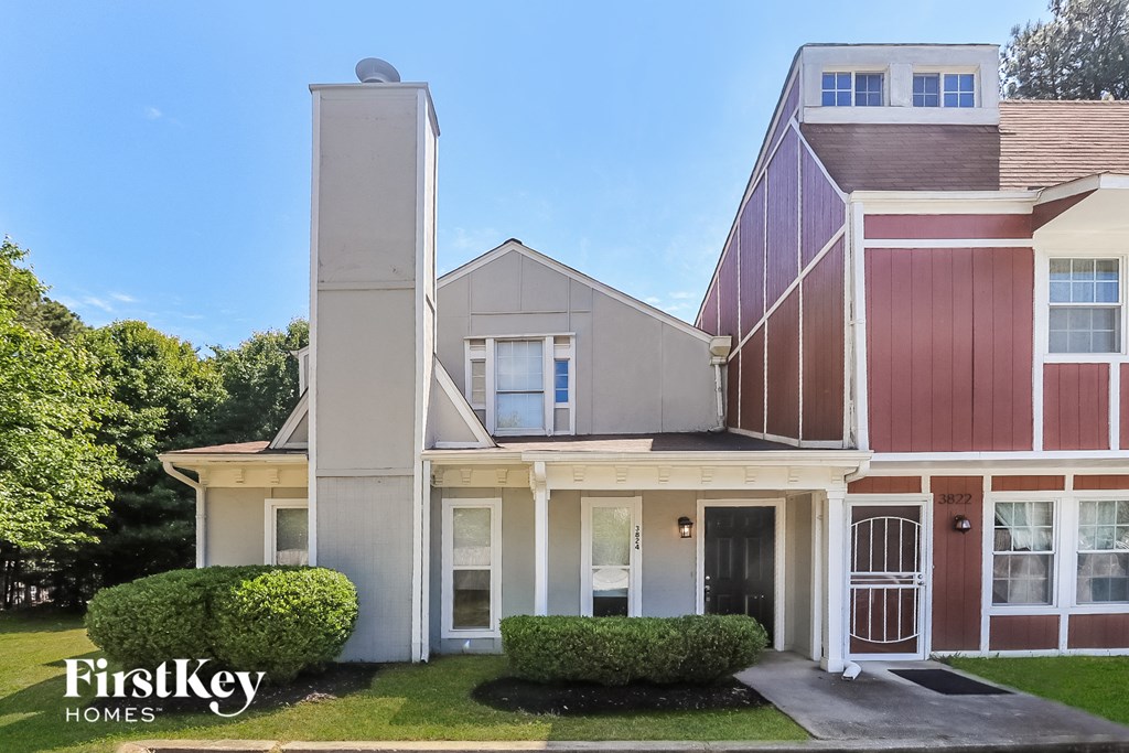 A house with a red and white facade is for sale.