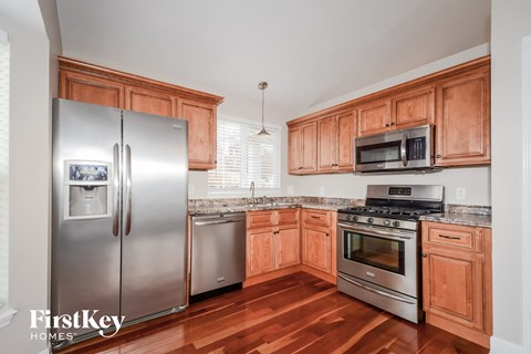 a kitchen with wooden cabinets and stainless steel appliances