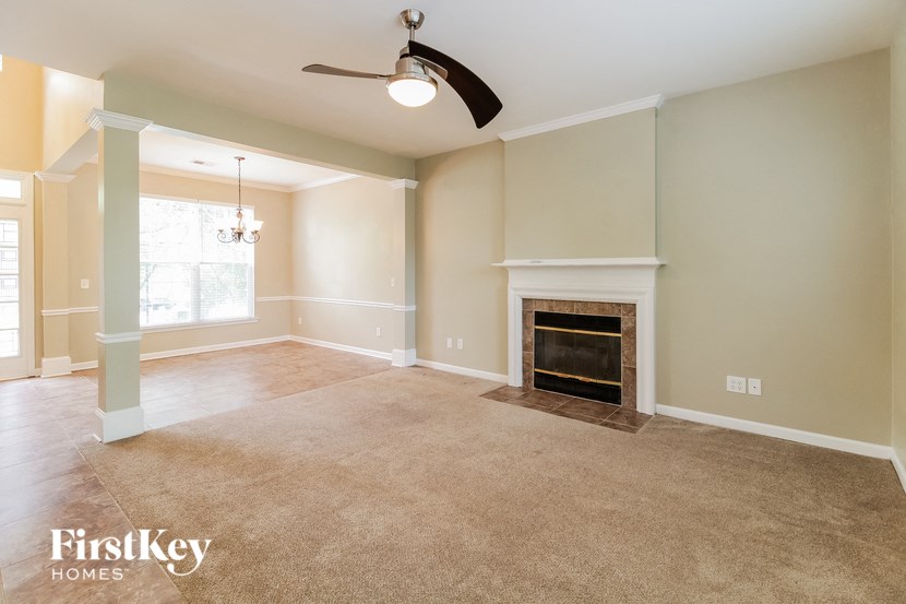 the living room of an empty house with a fireplace