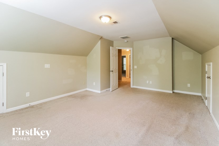 the master bedroom is spacious and has a carpeted floor