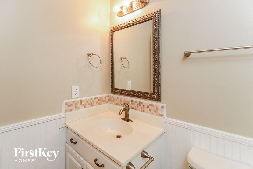 a small bathroom with a white sink and a mirror