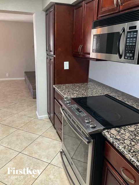 a kitchen with stainless steel appliances and granite counter tops