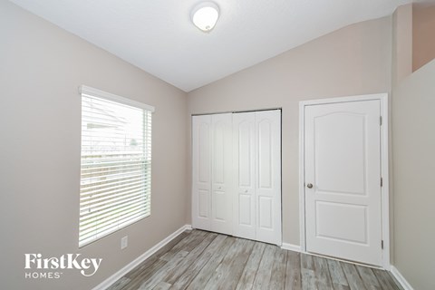 the second bedroom with two closets and a window