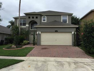 a house with a garage door in front of it