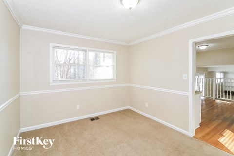 a living room with a carpeted floor and a window