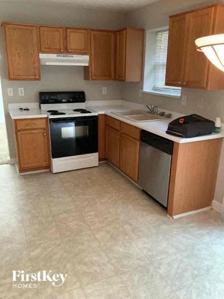 a kitchen with a stove and a sink