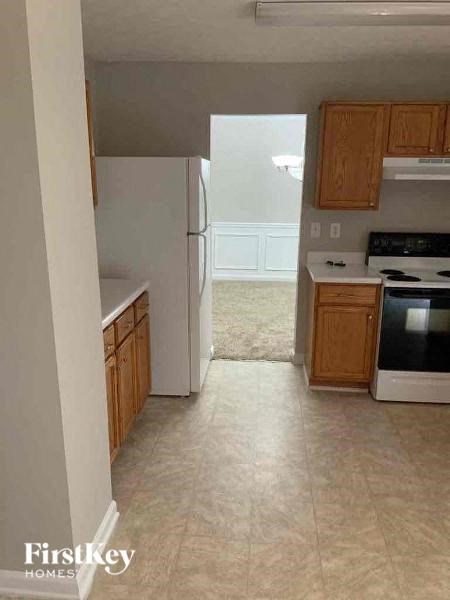a kitchen with a stove and a refrigerator