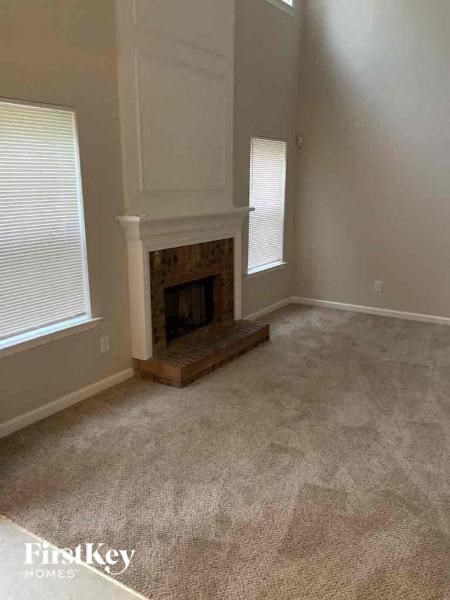 a living room with a fireplace and a carpet
