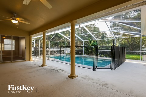 A room with a pool and a ceiling fan.