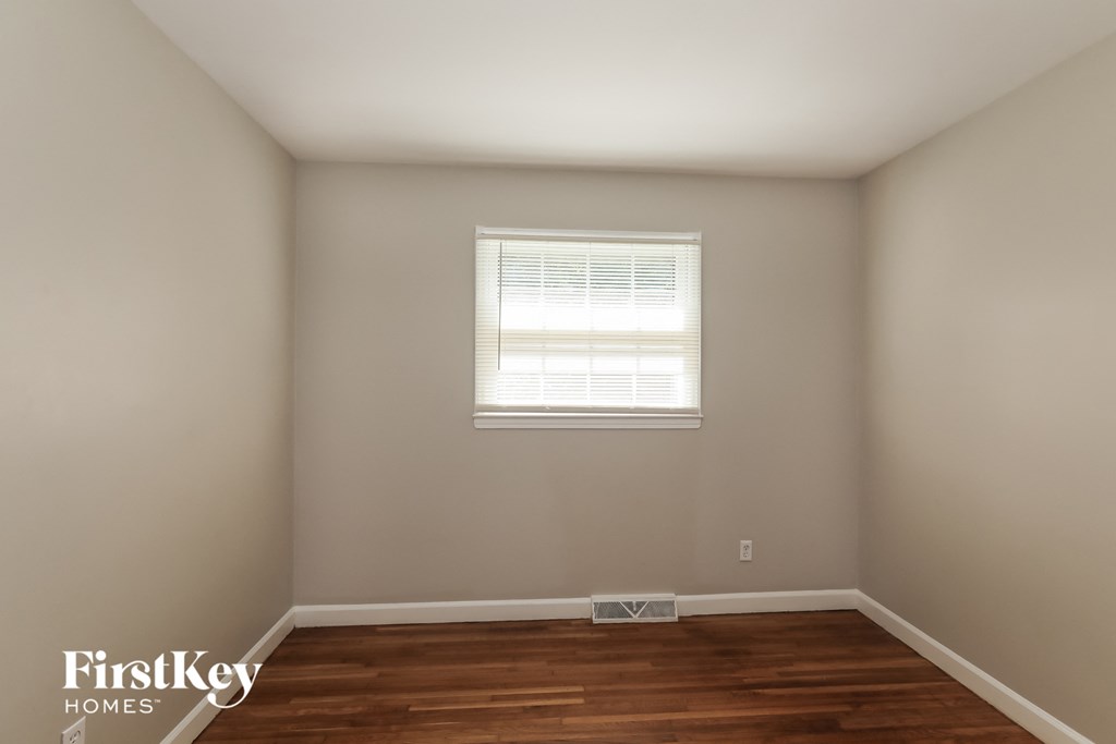a room with wooden floors and a window