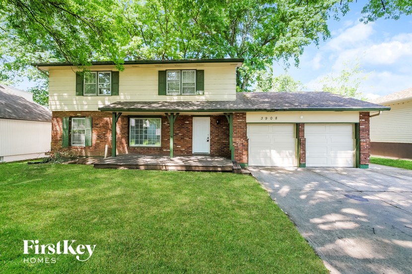 A two-story house with a garage on the right side.