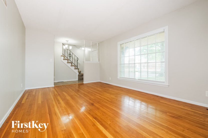 A room with wooden floors and a staircase.