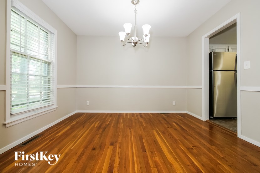 A room with wooden floors and a chandelier.