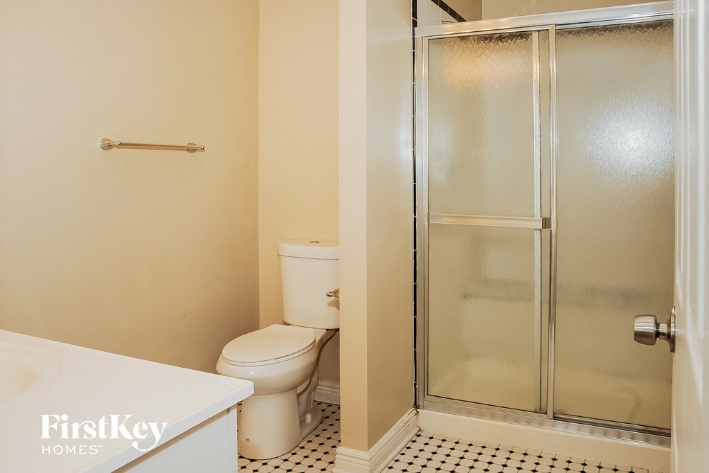 a bathroom with a toilet and a shower