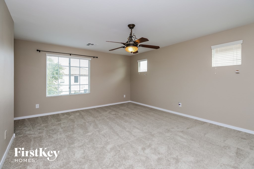 the master bedroom is spacious and has a ceiling fan