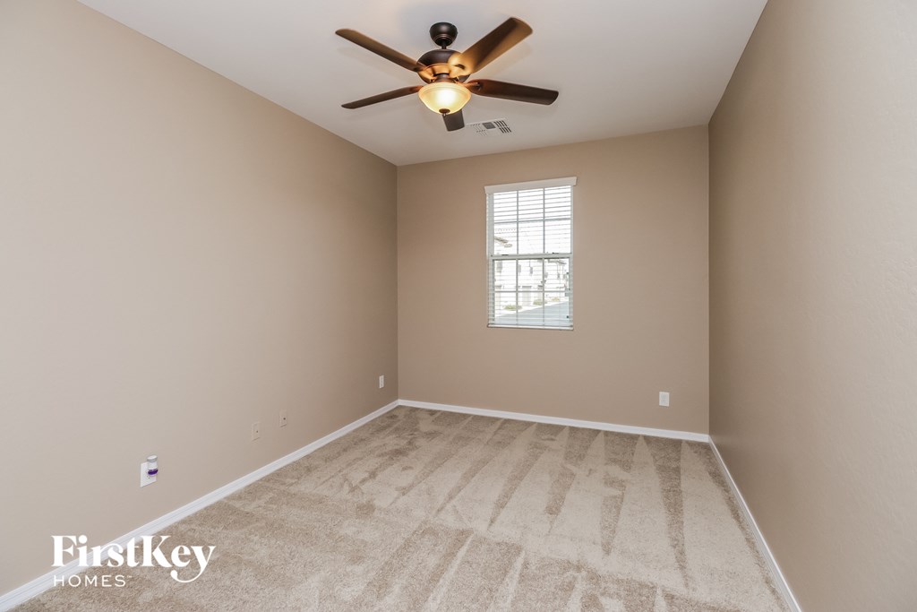 the master bedroom is spacious and has a ceiling fan