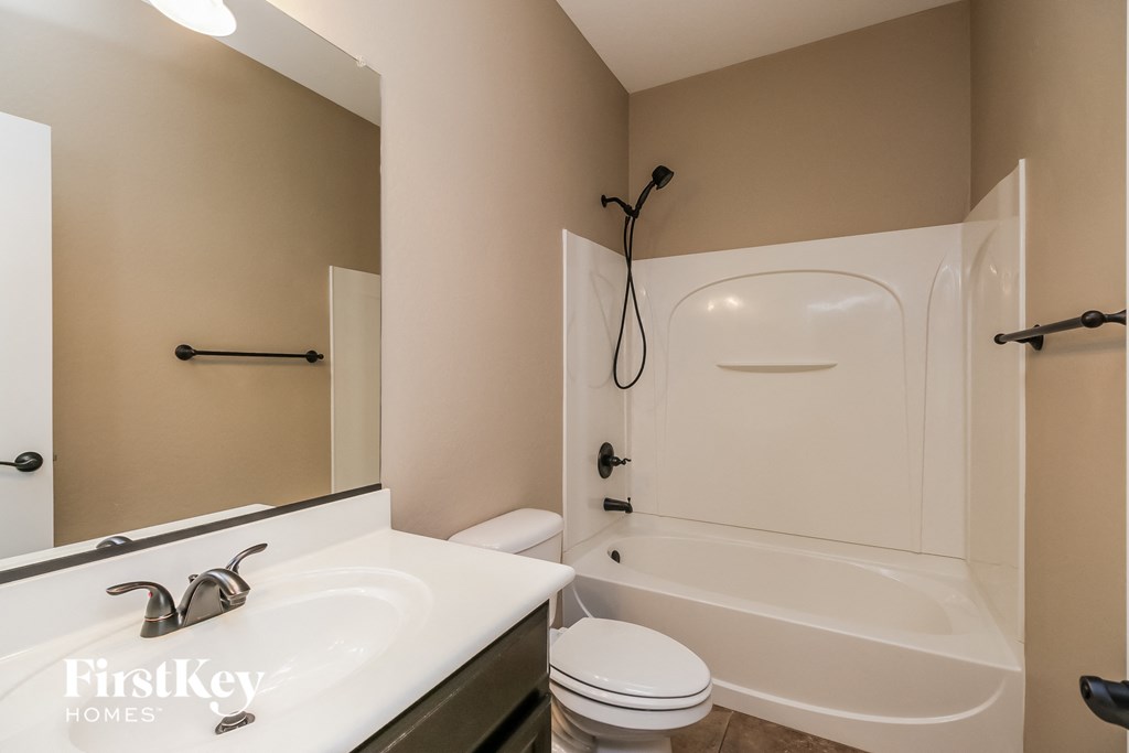 a bathroom with a sink and a toilet and a bath tub
