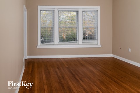 a living room with wood floors and a large window