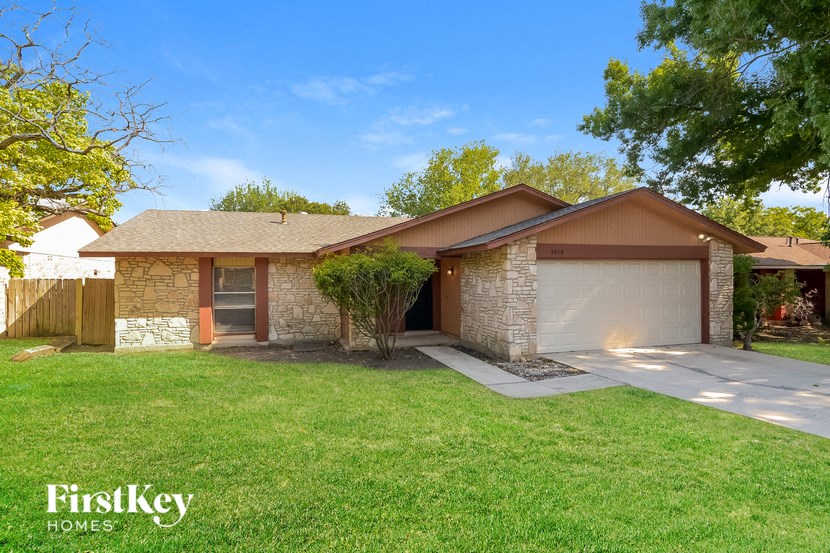 a house with a lawn and a driveway
